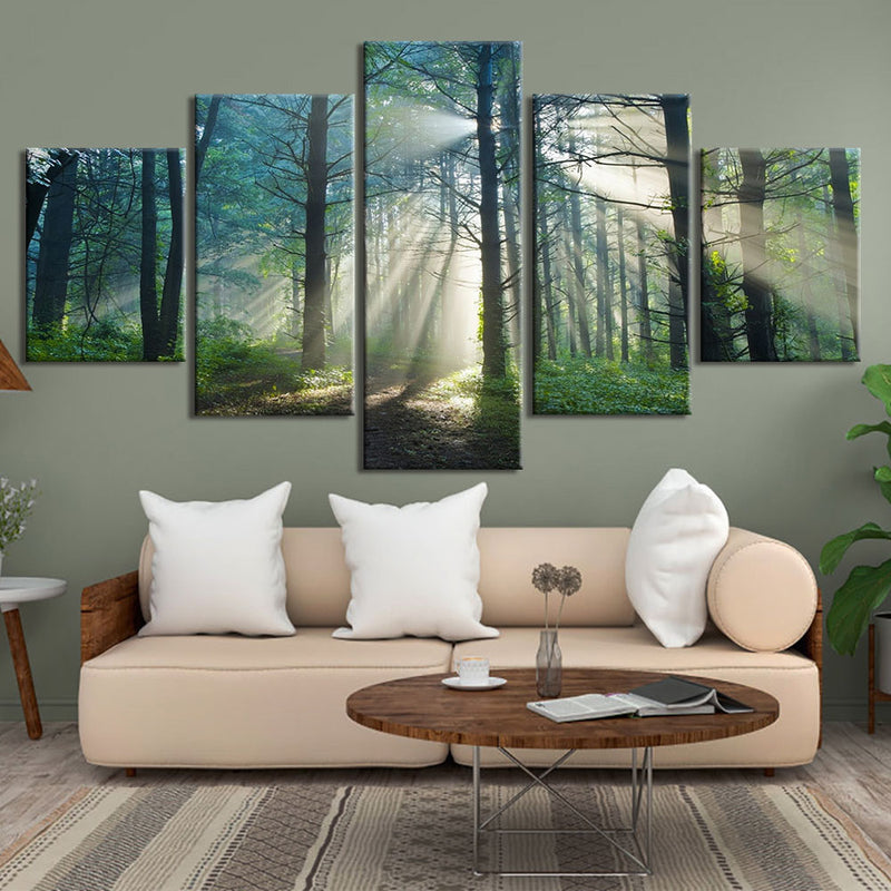 Tranquil Forest Scene: Sunbeams pierce through morning mist in a lush green forest, casting ethereal rays between tall trees, split across five canvas panels displaying a serene woodland path with verdant undergrowth