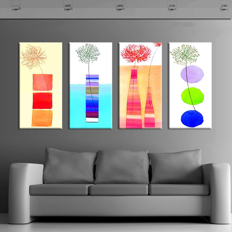 Modern Kitchen Panels featuring four abstract canvas prints with colorful geometric designs, flowers, and vases in vibrant red, blue, green, and orange tones, displayed as a contemporary wall art set above a grey sofa