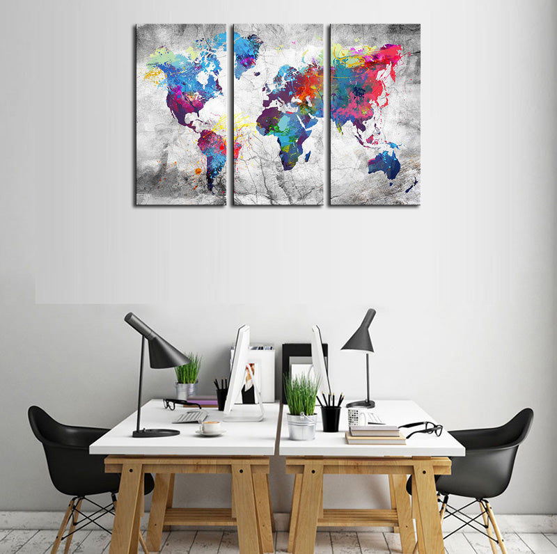 World Map in Paint Spatter - Modern 3-panel canvas wall art featuring vibrant watercolor splashes forming continents on a textured grey background, perfect for contemporary home decor