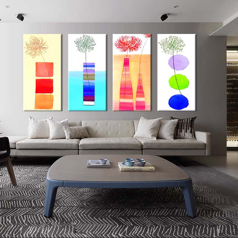 Modern Kitchen Panels featuring four abstract floral art pieces with vibrant geometric shapes in red, blue, green, and orange, displayed above a modern gray sofa in a contemporary living space
