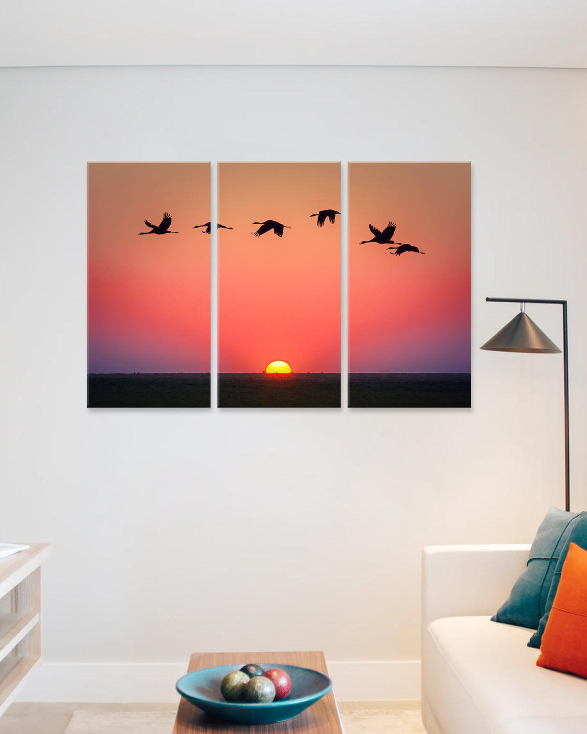 Birds Flying Over the Sunset - 3-panel canvas wall art featuring silhouettes of birds in flight against a vibrant orange and purple sunset sky, with a golden sun setting on the horizon, perfect for home decor