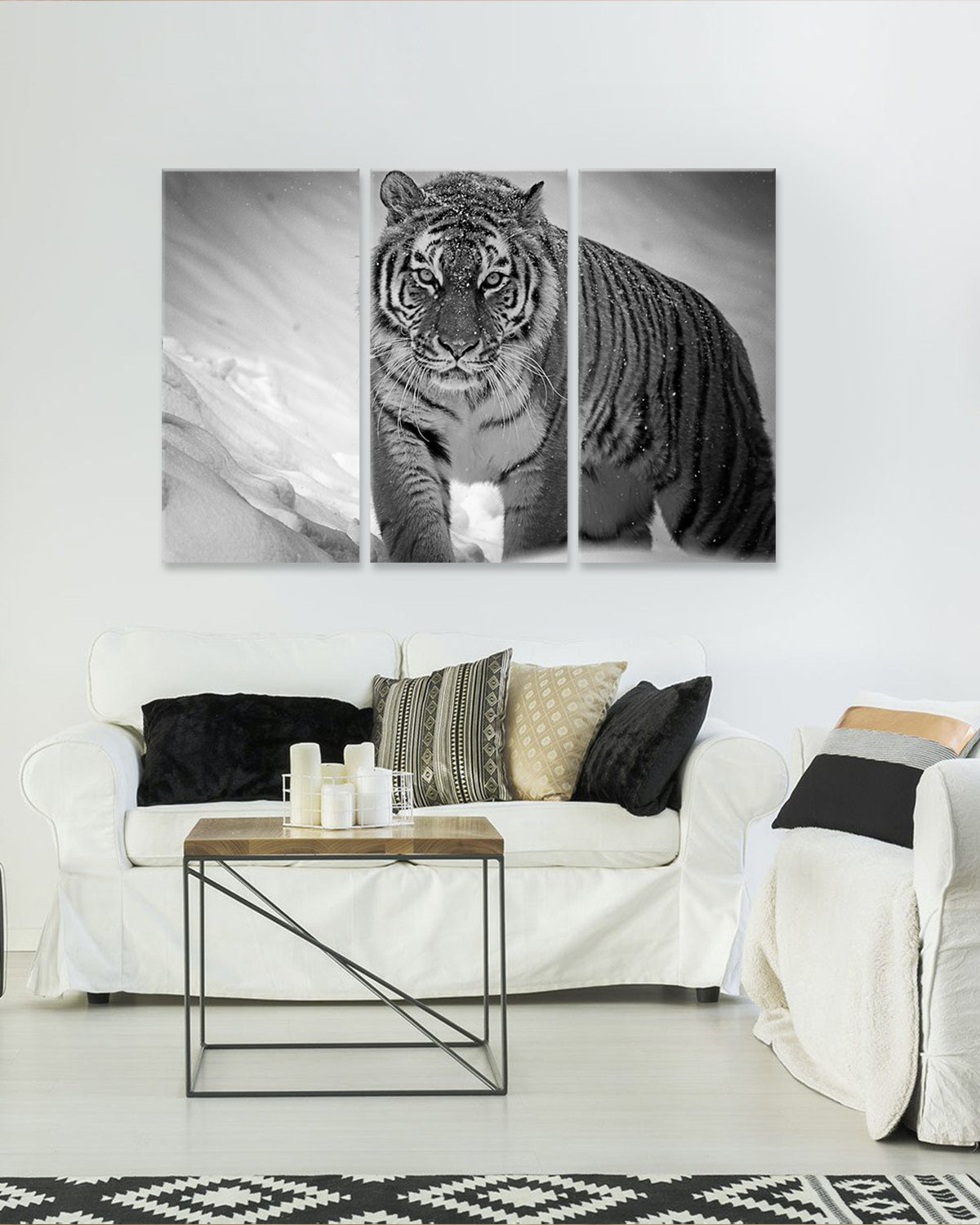 Black and White Tiger: Striking monochrome 3-panel canvas wall art featuring a majestic tiger with intense gaze in snow, displayed above modern living room furniture, perfect for dramatic home decor