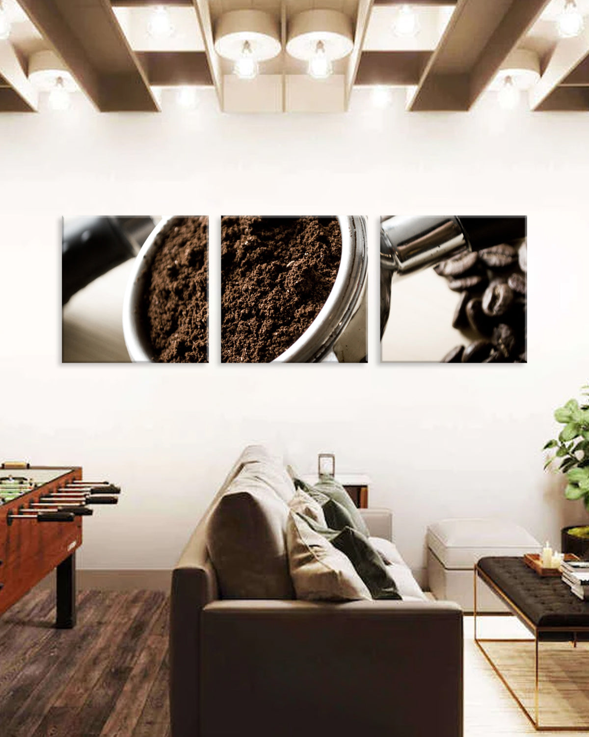 Espresso Grinds wall art featuring a triptych canvas print displaying close-up views of fresh coffee grounds, a container, and coffee beans in black and white tones, mounted above a modern living room sofa