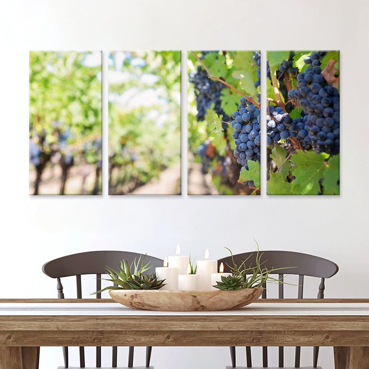 The Vinyard - 4-panel canvas wall art featuring ripe purple wine grapes on the vine in a sunlit vineyard, displayed above a rustic wooden dining table with decorative centerpiece