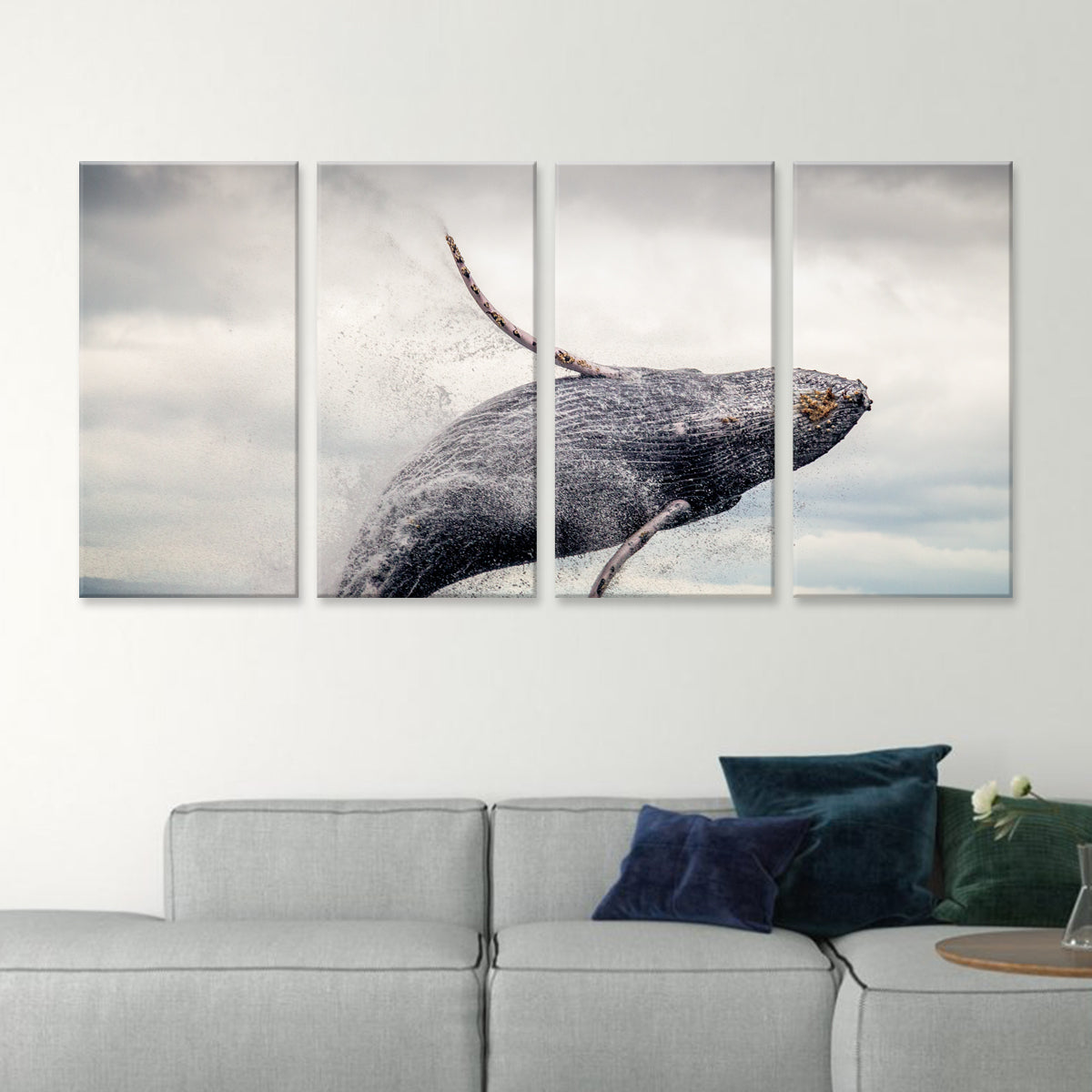 Jumping Whale canvas wall art featuring a majestic humpback whale breaching the ocean surface in dramatic 4-panel split design, with water droplets spraying against cloudy sky backdrop