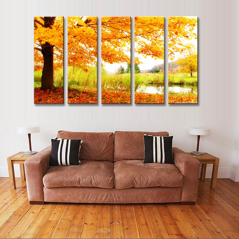 Maple Tree Fall Landscape: 5-panel canvas art showing vibrant autumn maple tree with golden-orange leaves, scattered fall foliage on ground, sunlit meadow background, creating serene nature scene perfect for home decor