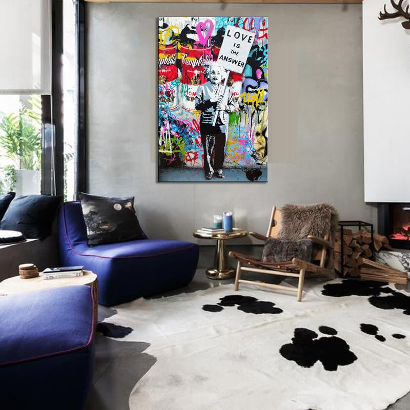 Love Is The Answer Banksy canvas print featuring vibrant street art with colorful graffiti background displayed in modern living room with blue sofa and contemporary decor