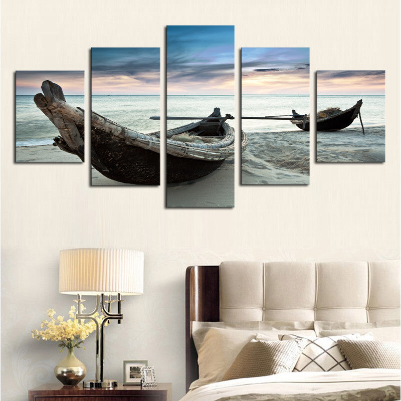 Canoes on the Beach: Weathered wooden fishing boats resting on tranquil sandy shore at sunset, panoramic 5-panel canvas wall art displaying serene coastal landscape with gentle waves and pastel sky
