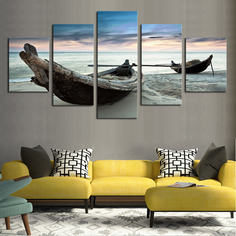 Canoes on the Beach - Five panel canvas wall art displaying weathered wooden boats resting on a tranquil beach at sunset, with soft pastel skies reflecting on calm ocean waters