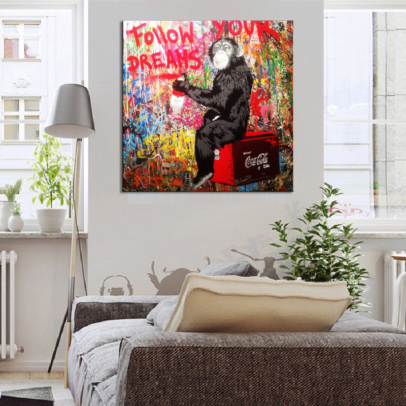 Follow Your Dreams Monkey Banksy canvas print showing a chimpanzee sitting on a red Coca-Cola crate against vibrant graffiti background with text Follow Your Dreams in street art style