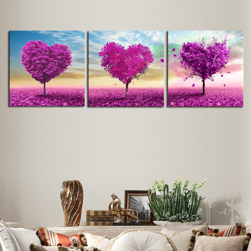 Purple Heart Trees canvas wall art featuring three vibrant magenta heart-shaped trees against pastel skies, with falling petals and a pink-hued field, perfect for romantic home decor