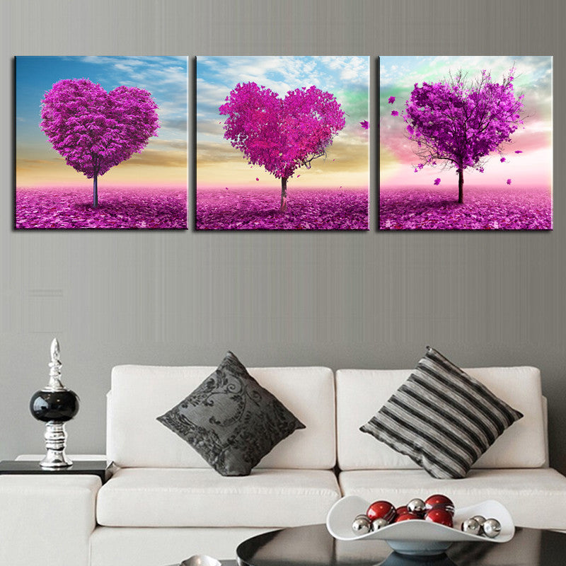 Purple Heart Trees canvas wall art featuring three vibrant magenta heart-shaped trees against pastel skies, set on purple flowering fields in a romantic triptych design perfect for home decor