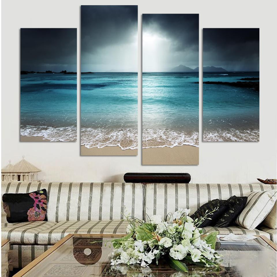 Dark Beach Scene: Four-panel canvas art displaying moody turquoise ocean waters under stormy gray skies, with gentle waves breaking on sandy shore, creating dramatic coastal atmosphere at dusk