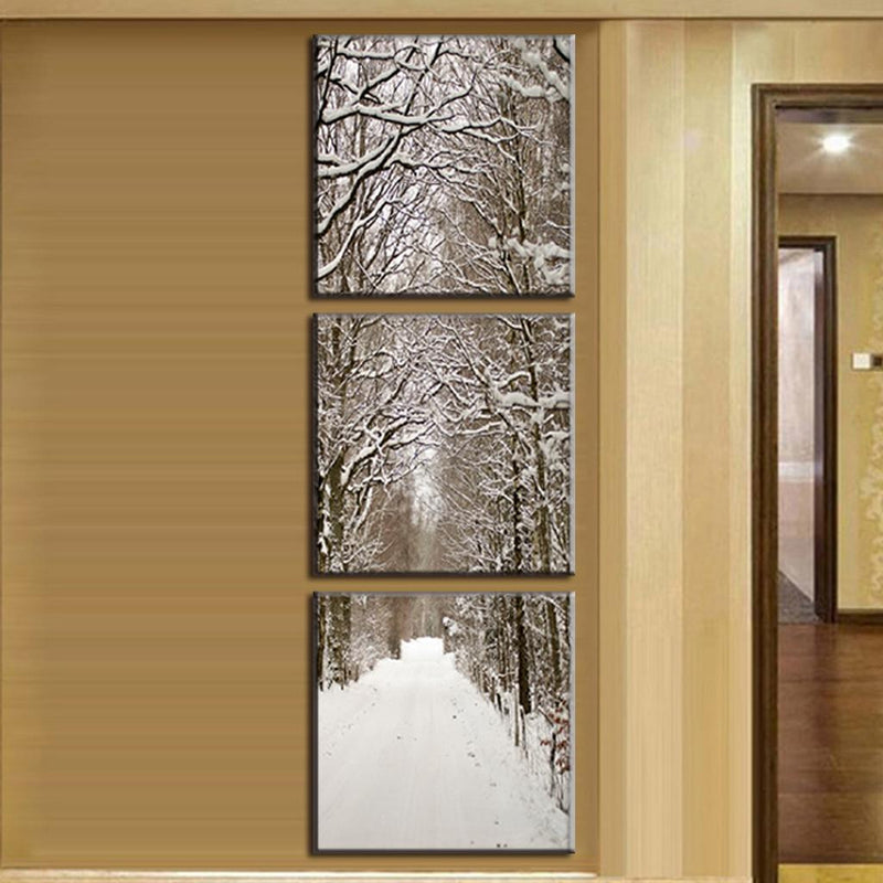 Snowy Winter Boulevard - Vertical three-panel canvas wall art featuring a serene snow-covered tree-lined path, with snow-laden branches forming a natural archway over a pristine white winter walkway