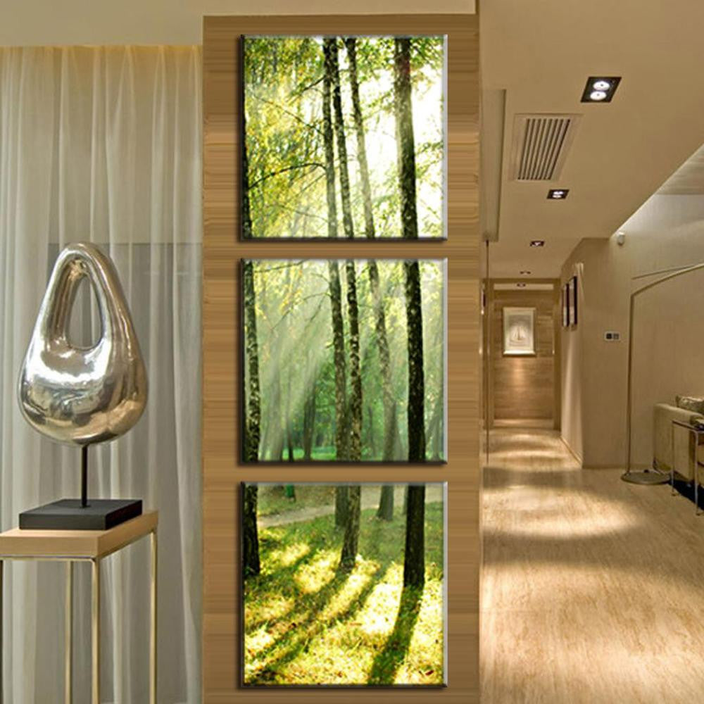 Sunshine Through the Trees - Three-panel canvas wall art featuring sunlit forest scenery with towering trees casting long shadows on mossy ground, creating a serene natural atmosphere in modern interior setting