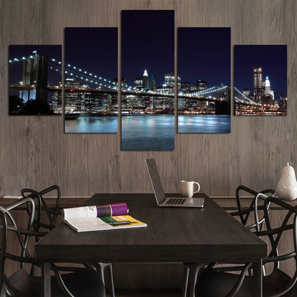 New York City Skyline canvas wall art featuring illuminated Brooklyn Bridge and Manhattan skyline at night, reflected in East River waters with glowing city lights across 5 panels for modern home decor
