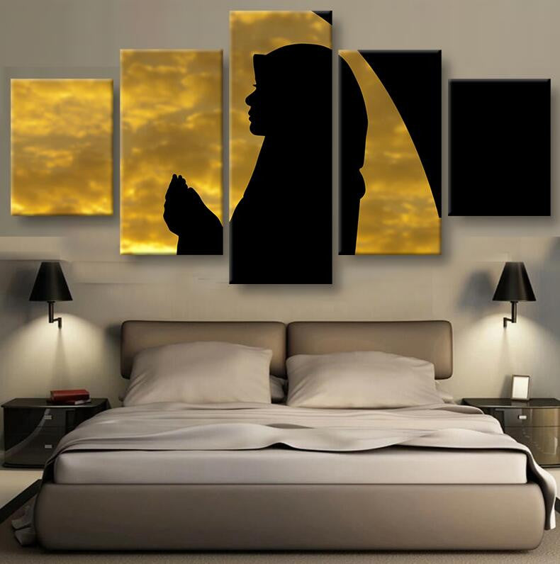 Silhouette in the Moonlight - A dramatic 5-panel canvas wall art featuring a dark silhouette of a praying figure against a luminous golden sky with glowing clouds, creating a serene and spiritual atmosphere in multiple piece configuration