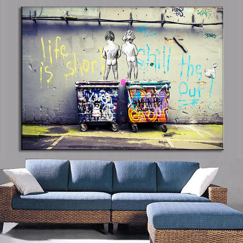 Life is Short, Chill the Duck Out - Urban street art showing two silhouettes standing on graffitied dumpsters against a concrete wall with spray-painted yellow and blue lettering, displayed as canvas wall art