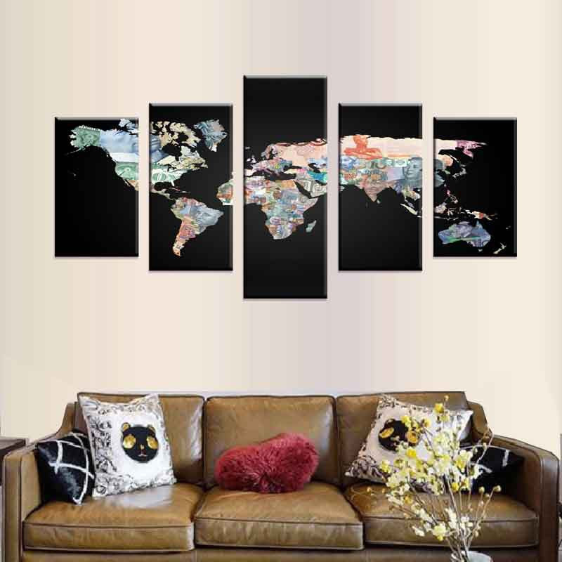 World Map in Currency Notes: 5-panel canvas wall art featuring global map design created with colorful international banknotes on black background, displayed above brown leather sofa in modern living room setting