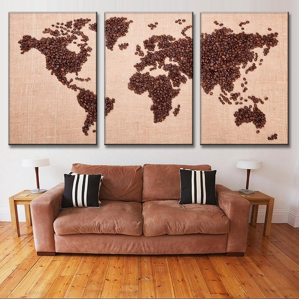 World Map in Coffee Beans - Three-panel canvas art featuring continents artistically created with coffee beans against a beige background, displayed above brown sofa in modern living room setting