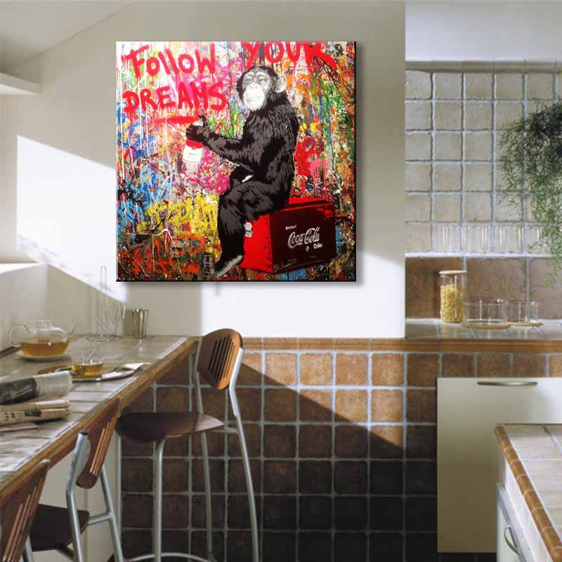 Follow Your Dreams Monkey Banksy canvas wall art featuring vibrant street art of a contemplative chimpanzee sitting on a red crate against colorful graffiti background with bold text message displayed in modern living space