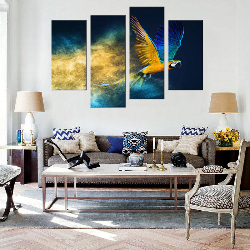 Blue Abstract Parrot 4-panel wall art featuring vibrant blue and yellow macaw in flight against mystical cosmic background, displayed above modern gray sofa in contemporary living room setting