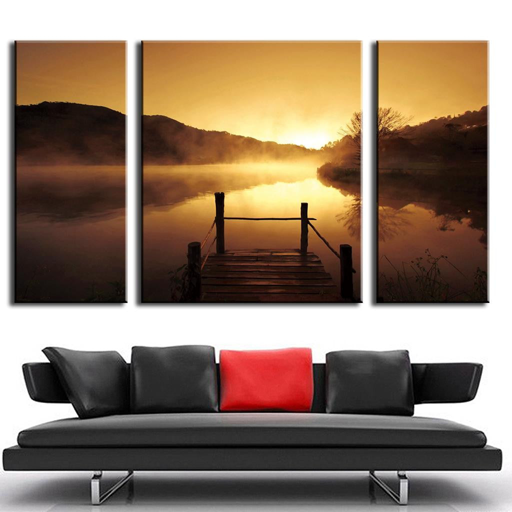 Sunset on the Dock - 3 panel canvas art showing wooden pier extending over misty lake at golden sunset, with silhouetted mountains and reflective water creating serene landscape atmosphere