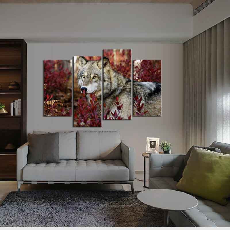 Wolf and Red Leaves canvas wall art featuring a majestic wolf against vibrant red autumn foliage, split into multiple panels, displayed above a modern grey sofa in a contemporary living room setting