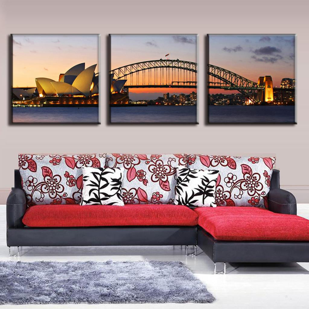 Sydney Opera House and Harbour Bridge: Beautiful 3-panel canvas wall art featuring iconic Sydney landmarks at sunset, with golden Opera House sails and illuminated Harbor Bridge spanning the tranquil waters of Sydney Harbor