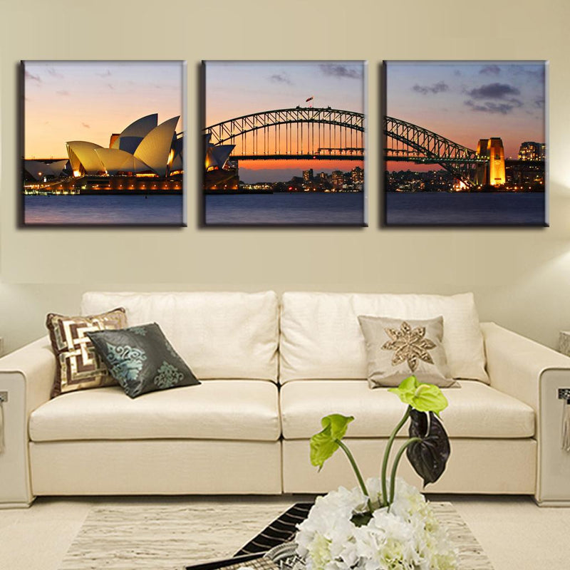 Sydney Opera House and Harbour Bridge canvas wall art featuring stunning sunset panorama of iconic Australian landmarks with illuminated architectural details against orange and purple twilight sky, perfect for home decor