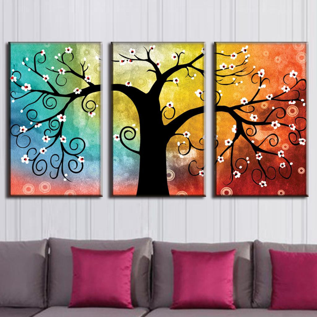 Tree with Abstract Design - 3-panel canvas wall art featuring a whimsical black tree silhouette with swirling branches and white blossoms against a vibrant rainbow gradient background from turquoise to orange