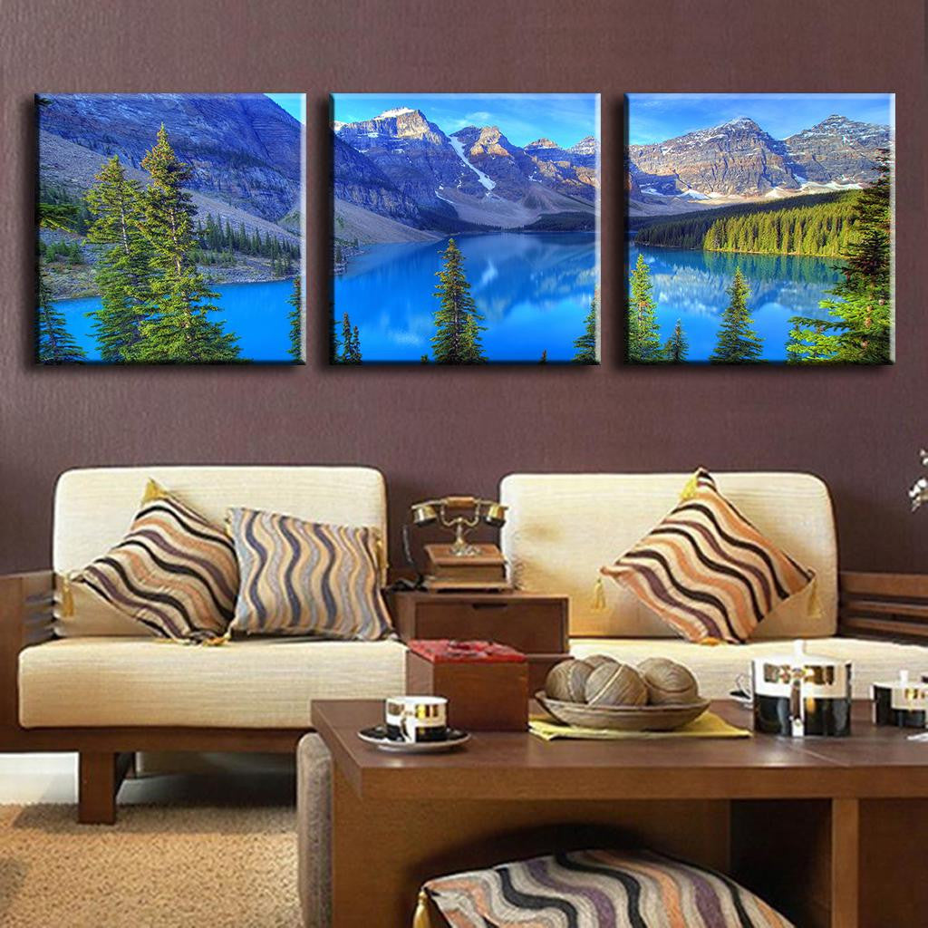 Blue Mountain Alps canvas wall art featuring serene mountain lake landscape with turquoise waters, snow-capped peaks, and evergreen trees, displayed as 3-piece panel set for modern home decor