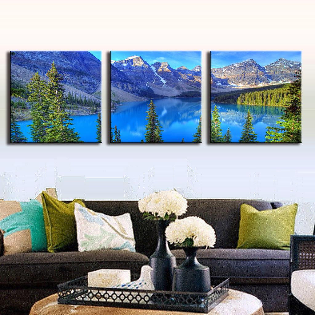 Blue Mountain Alps - Stunning 3-panel canvas art featuring serene mountain landscape with crystal blue lake, snow-capped peaks, and evergreen trees reflecting in pristine alpine waters at sunrise
