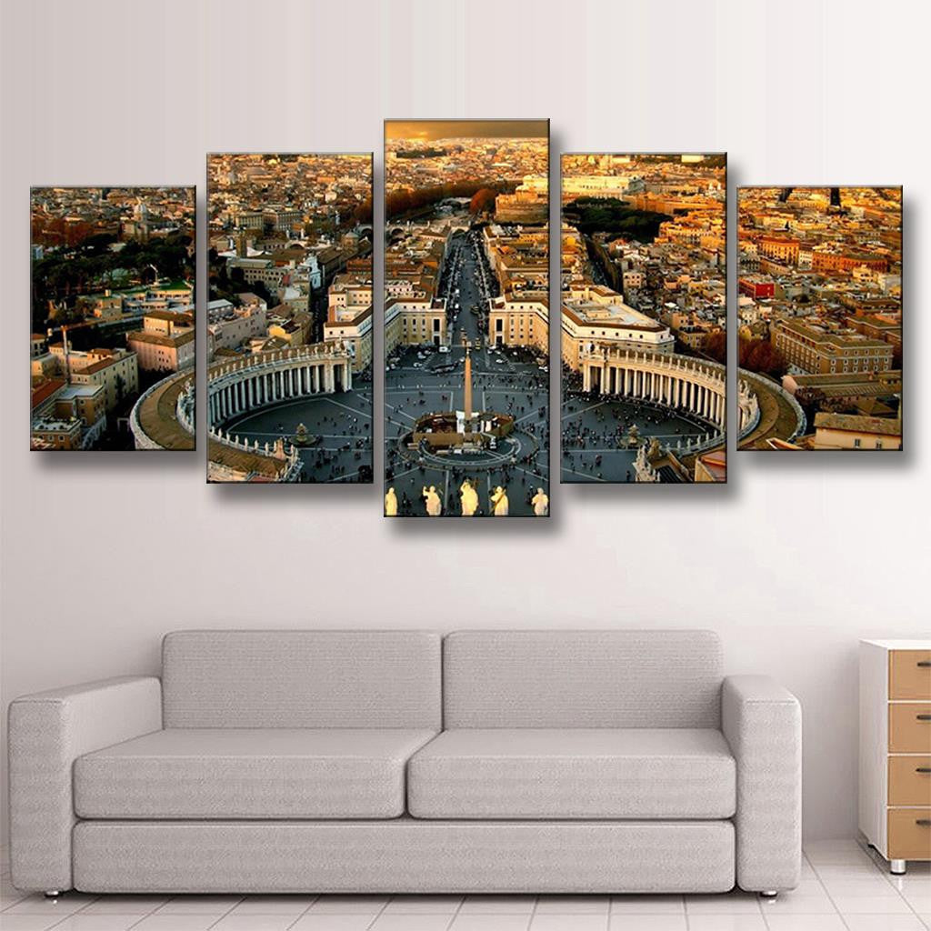 The Roman Forum Panoramic wall art showcasing an aerial view of St. Peter's Square in Vatican City, featuring the iconic colonnade, obelisk and surrounding historic Roman architecture at sunset, displayed as a 5-panel canvas print