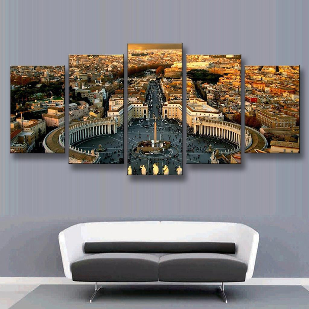 The Roman Forum Panoramic - Aerial view of St. Peters Square in Vatican City at sunset, showcasing historic architecture with colonnade, central obelisk and surrounding Roman cityscape in warm golden light, displayed as 5-panel canvas wall art