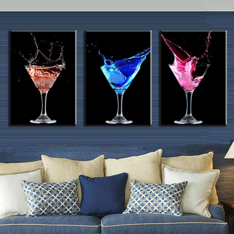 Colorful Cocktails: Three-panel wall art featuring vibrant martini glasses with splashing liquid in red, blue, and pink against black backgrounds, creating dynamic and sophisticated bar or dining room decor