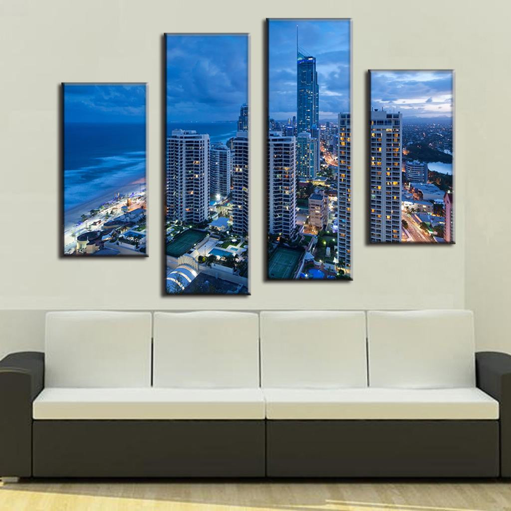 Blue Cityscape Beach 4-panel canvas art showcasing illuminated modern skyscrapers along shoreline at dusk, featuring ocean waves, urban architecture and city lights in vibrant blue tones, perfect for contemporary wall decor