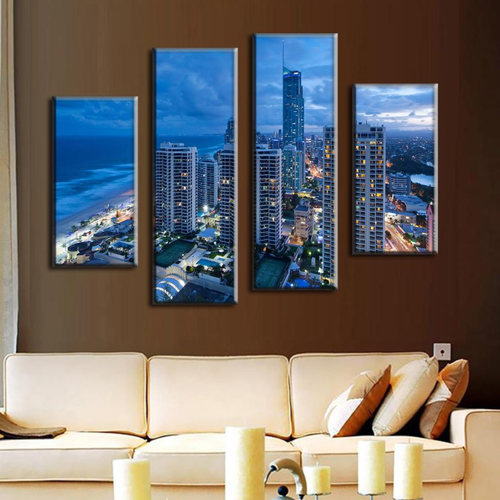 Blue Cityscape Beach - 4-panel canvas wall art showcasing dramatic night skyline of coastal city with illuminated skyscrapers, beachfront, and ocean views at dusk, displaying modern architecture against deep blue sky