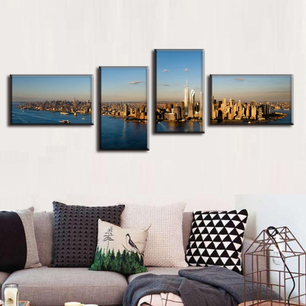 New York City Panorama - 4 piece canvas wall art showing aerial view of Manhattan skyline at sunset, with golden sun reflecting off skyscrapers and calm blue waters of Hudson River surrounding the iconic cityscape
