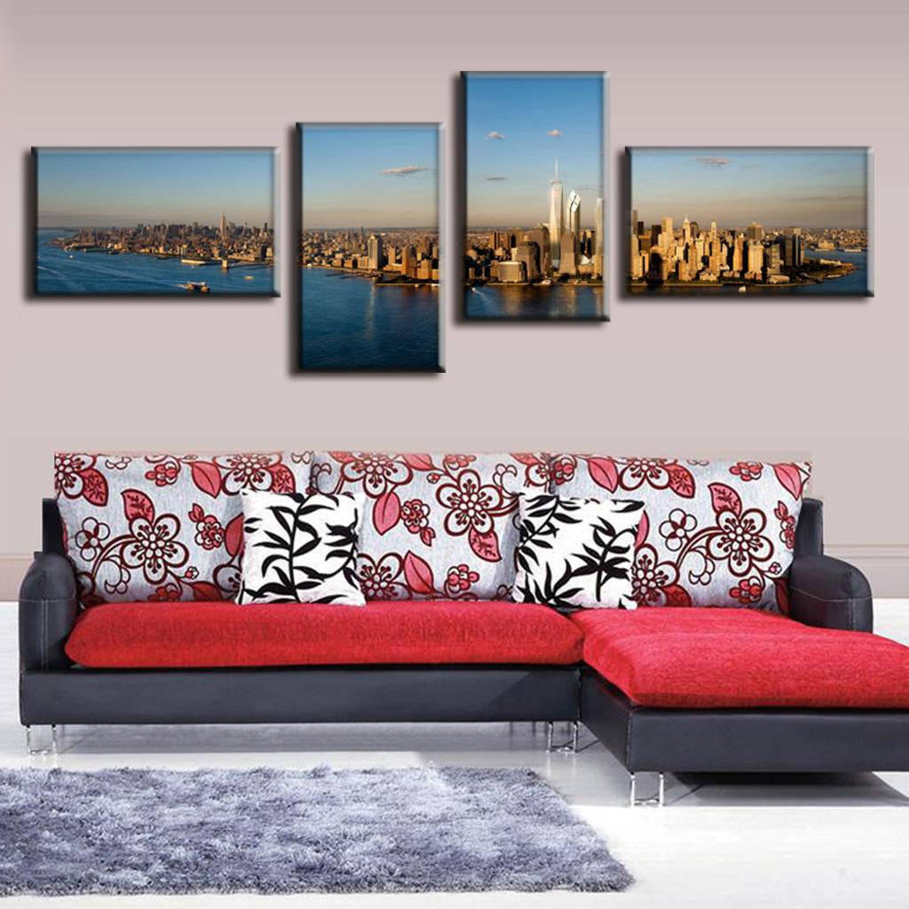 New York City Panorama: 4-piece canvas wall art showing aerial view of Manhattan skyline at sunset, featuring iconic Freedom Tower, Hudson River, and city skyscrapers in golden sunlight, spanning 48x24 inches