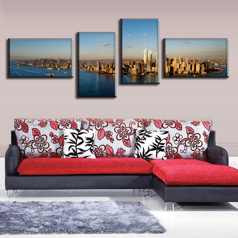 New York City Panorama: 4-piece canvas wall art showing aerial view of Manhattan skyline at sunset, featuring iconic Freedom Tower, Hudson River, and city skyscrapers in golden sunlight, spanning 48x24 inches