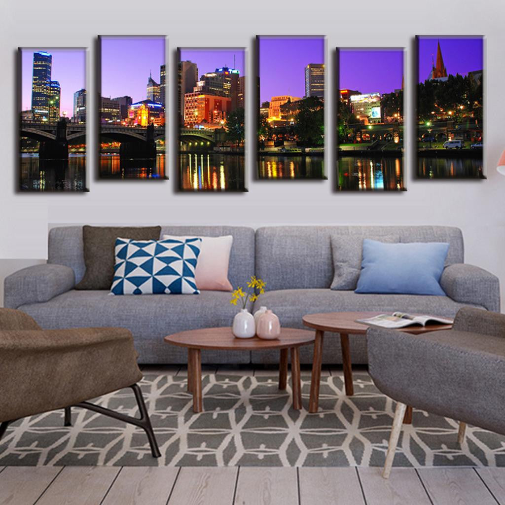 Cityscape Reflection on the Lake - Stunning 6-panel canvas wall art showing illuminated city buildings and skyscrapers at night with colorful lights reflecting on calm water, set against purple twilight sky, creating dramatic urban landscape scenery