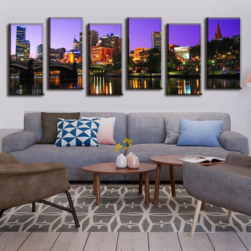 Cityscape Reflection on the Lake - Stunning 6-panel canvas wall art showing illuminated city buildings and skyscrapers at night with colorful lights reflecting on calm water, set against purple twilight sky, creating dramatic urban landscape scenery