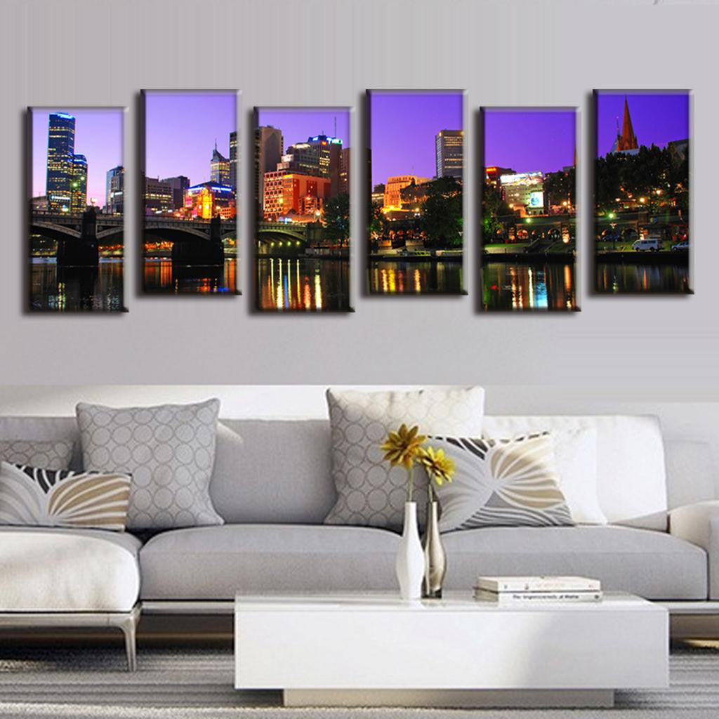 Cityscape Reflection on the Lake - 6 panel canvas art showing illuminated city buildings at night with vibrant reflections in water, featuring purple sky backdrop and colorful urban lights mirrored across a tranquil lake surface
