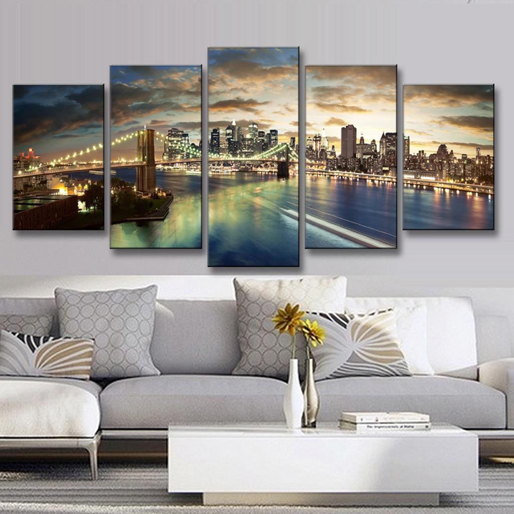 The Brooklyn Bridge Night Scene: Stunning 5-panel canvas art showcasing illuminated Brooklyn Bridge with dramatic sunset sky, Manhattan skyline reflections on East River, vibrant city lights and warm golden hues