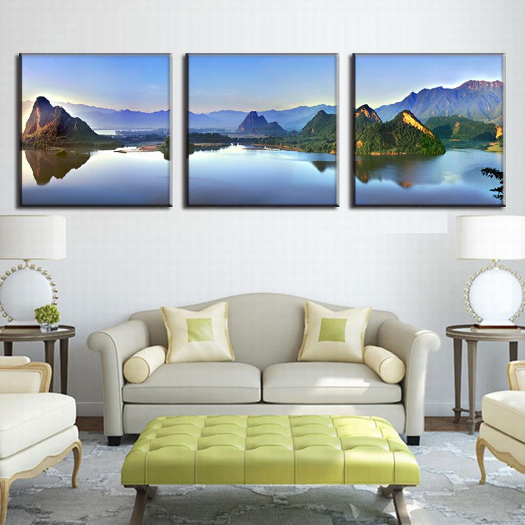 Lake and Mountain Landscape: Serene three-panel canvas print featuring tranquil mountain lake at sunrise, with dramatic peaks reflecting in crystal-clear waters, perfect for modern home decor