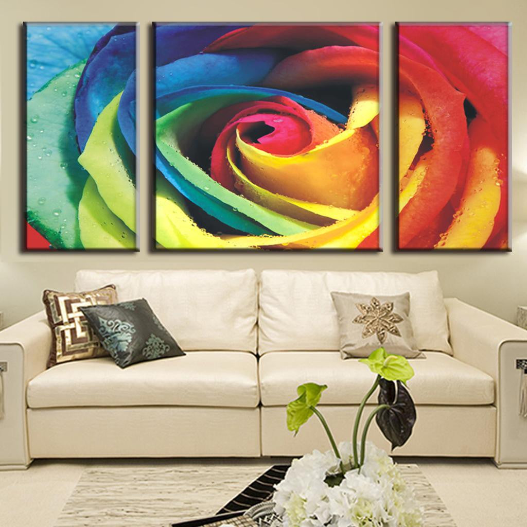 Abstract Rose with Colors - Vibrant rainbow-colored rose petals in close-up view, split across three canvas panels, displaying swirling patterns of blue, green, yellow, orange, and red tones with water droplets