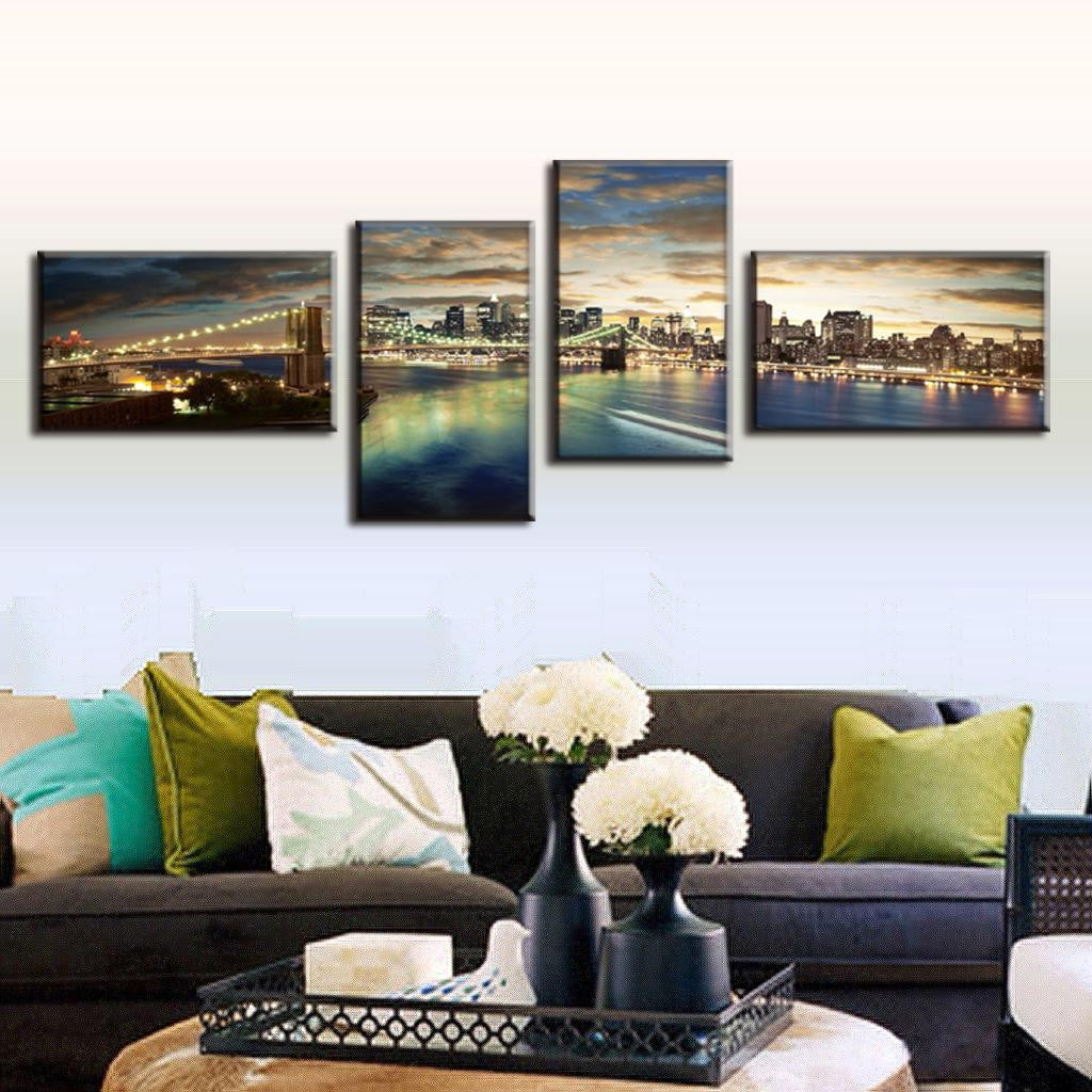 Brooklyn Panoramic at Night - Stunning 4-panel canvas art showing illuminated Brooklyn Bridge and Manhattan skyline reflecting on water at dusk with dramatic cloudy sunset sky, perfect for modern home decor