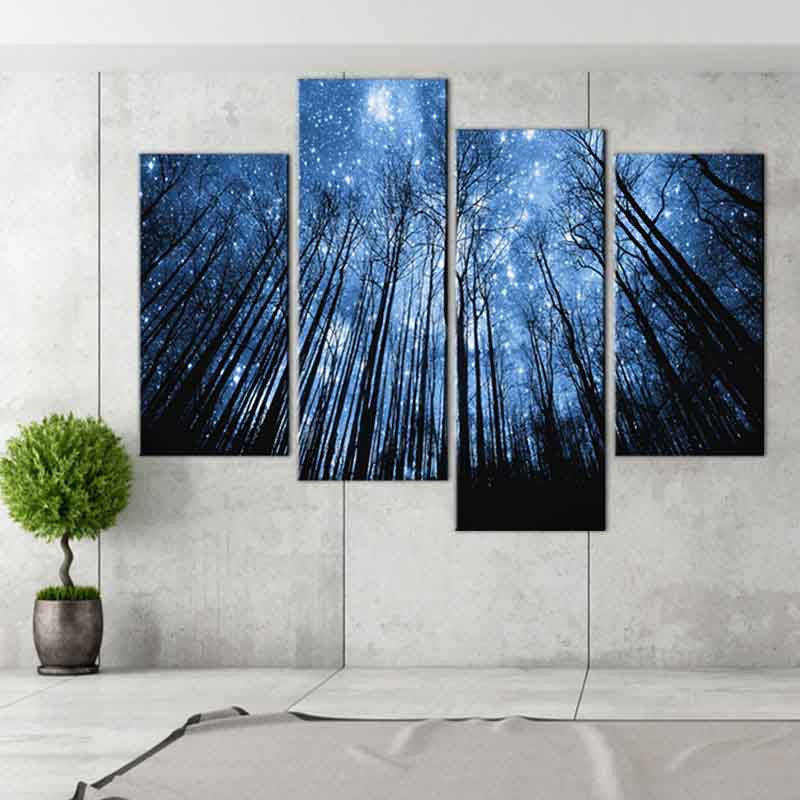 Blue Forest with Starry Sky - 4-panel canvas wall art featuring tall forest trees silhouetted against a mystical night sky filled with twinkling stars, creating a dramatic upward perspective in deep blue hues