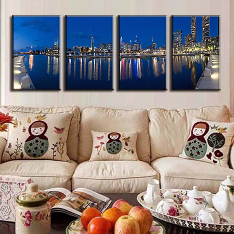 Blue City Night - 4-panel canvas wall art featuring stunning nighttime cityscape with illuminated skyscrapers reflected in calm waterfront, perfect modern urban decor for living spaces